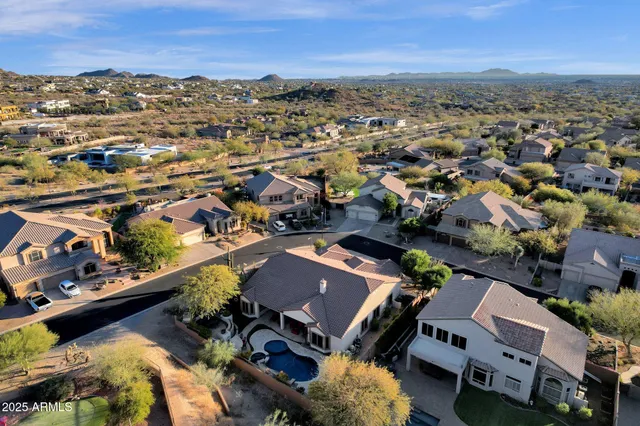 an aerial view of a houses with a swimming pool