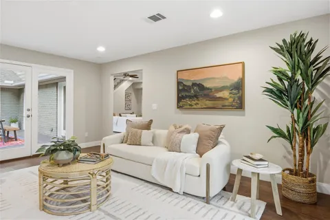 a kitchen with stainless steel appliances a dining table chairs refrigerator and sink