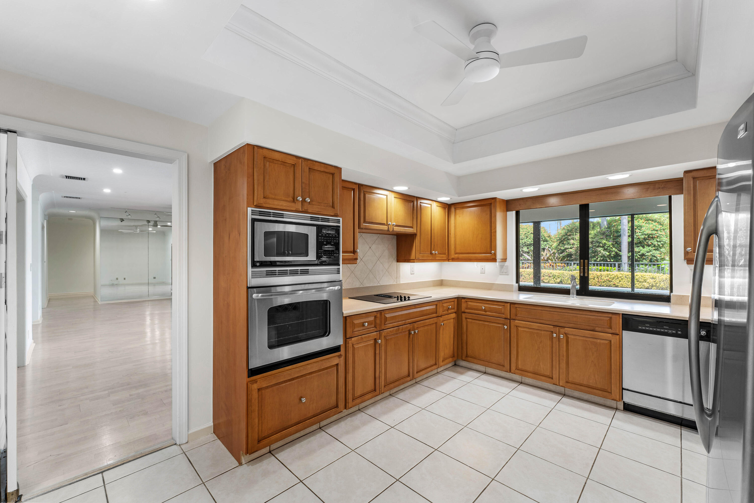1851 Thatch Palm Drive Boca Raton, FL 33432 - Photo 25 of 70 a kitchen with stainless steel appliances granite countertop a refrigerator and a sink