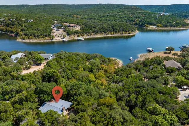 an aerial view of a house with a lake view