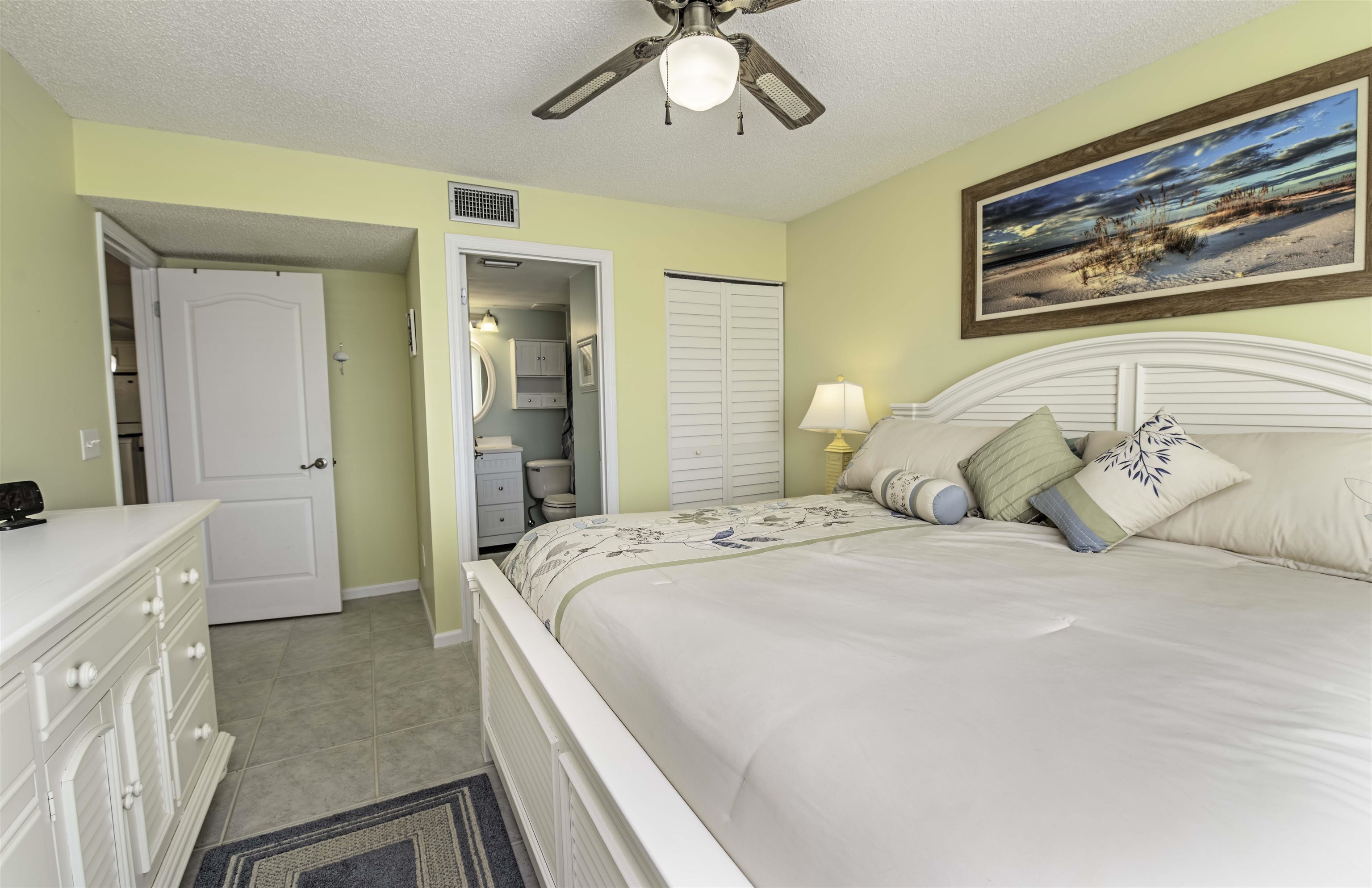 880 A1A Beach Boulevard, Unit 7302 St. Augustine, FL 32080 - Photo 11 of 28 a spacious bedroom with a bed and a chandelier
