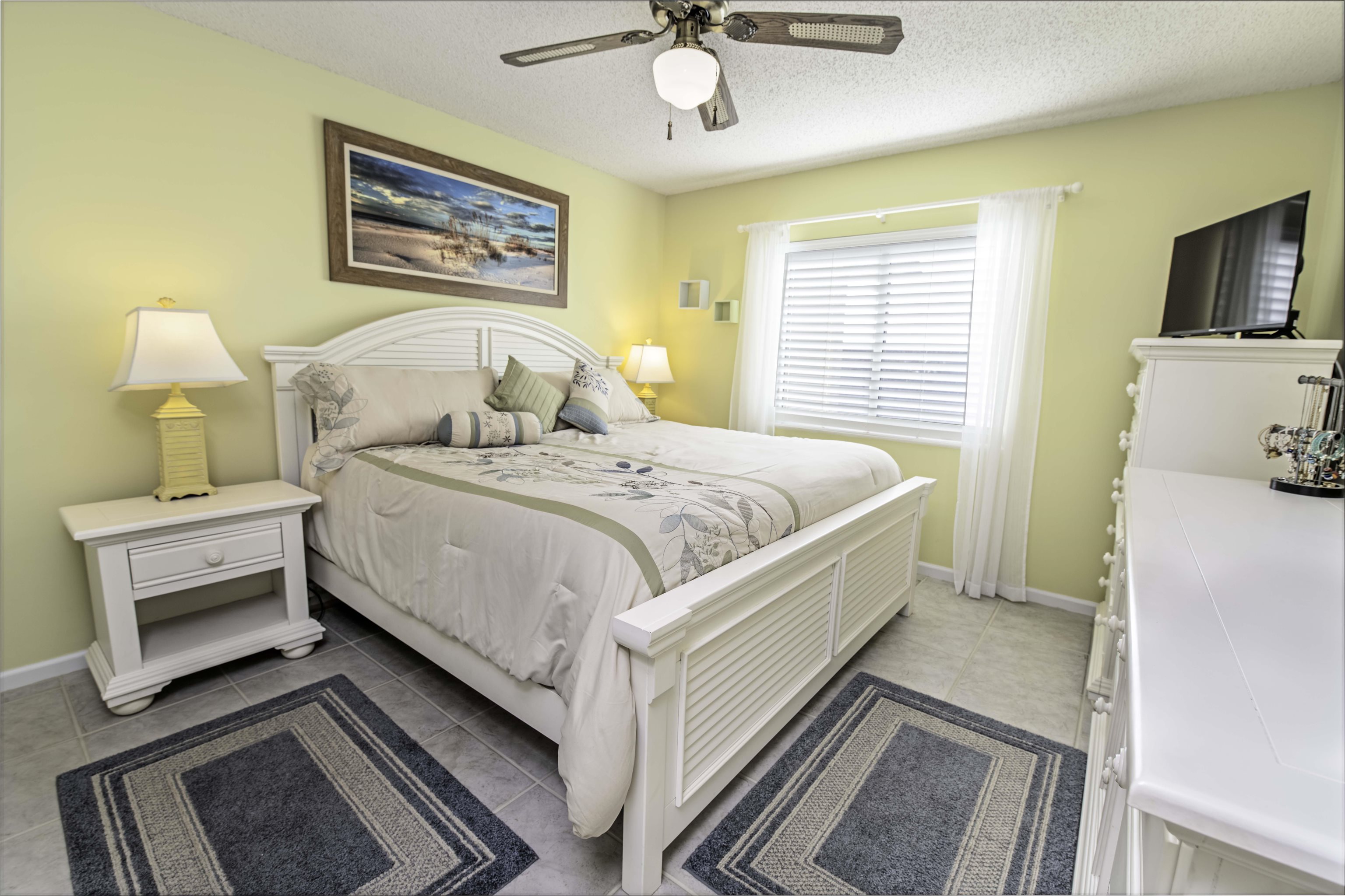 880 A1A Beach Boulevard, Unit 7302 St. Augustine, FL 32080 - Photo 12 of 28 a bedroom with a bed and a chandelier