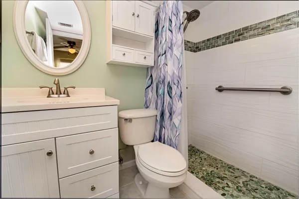 a bathroom with a toilet a sink and a mirror