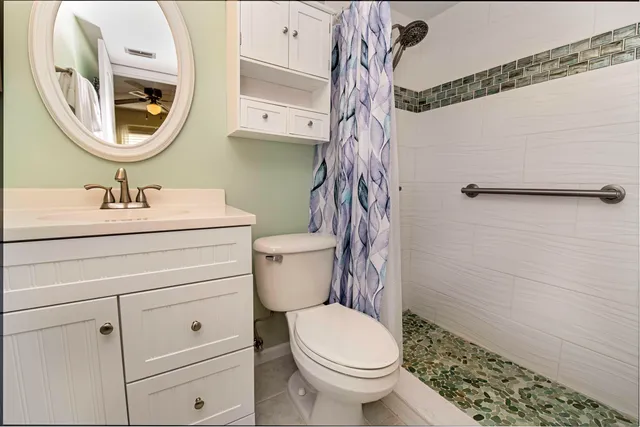 a bathroom with a toilet a sink and a mirror