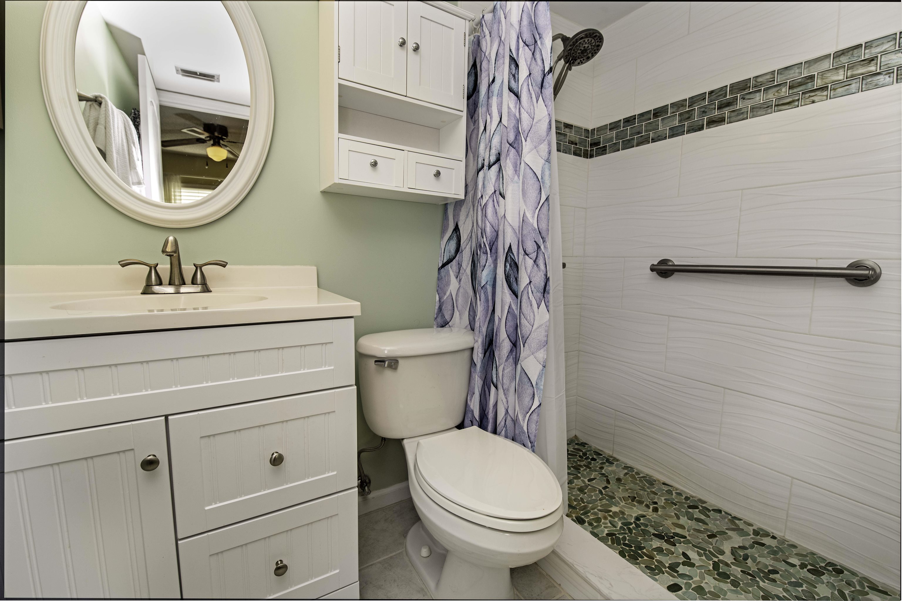 880 A1A Beach Boulevard, Unit 7302 St. Augustine, FL 32080 - Photo 13 of 28 a bathroom with a toilet a sink and a mirror