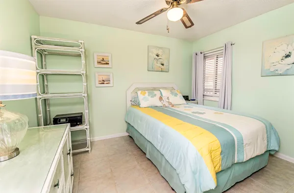 a bedroom with a bed and ceiling fan