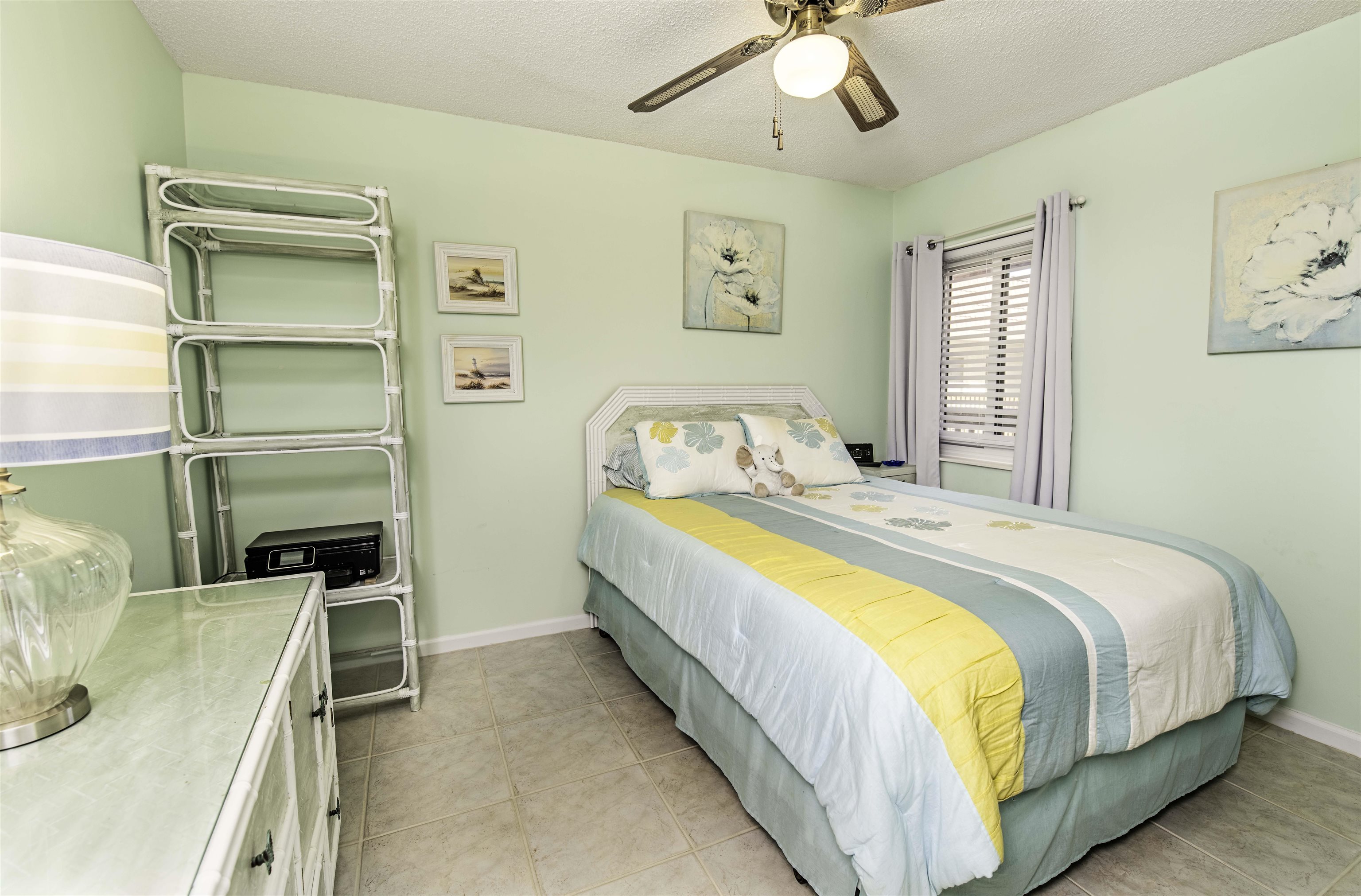 880 A1A Beach Boulevard, Unit 7302 St. Augustine, FL 32080 - Photo 14 of 28 a bedroom with a bed and ceiling fan