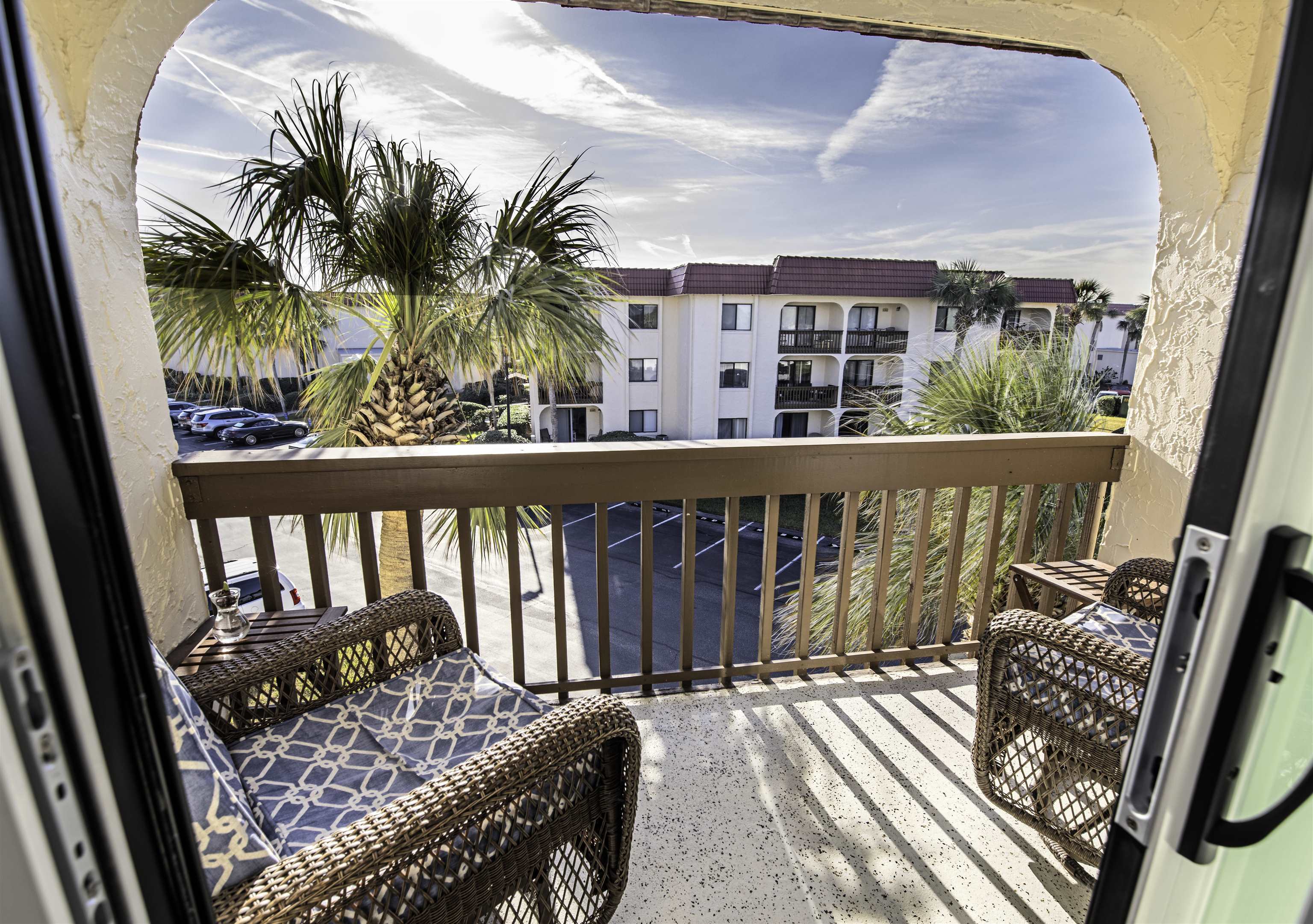 880 A1A Beach Boulevard, Unit 7302 St. Augustine, FL 32080 - Photo 17 of 28 a balcony with wooden floor table and chairs