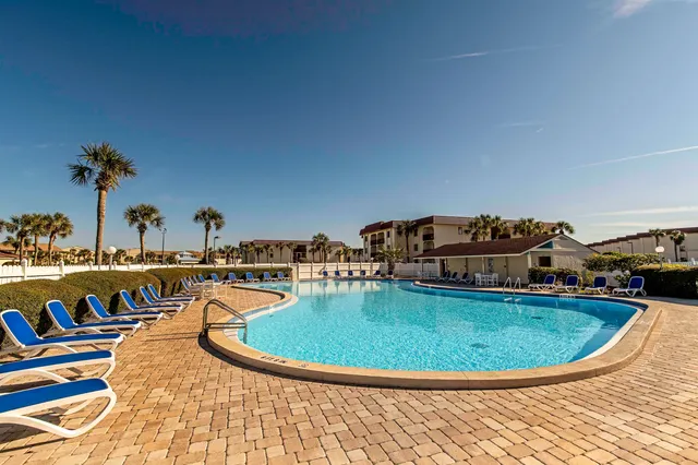 a view of a swimming pool with outdoor seating