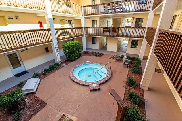 an outdoor view of a house with backyard and deck