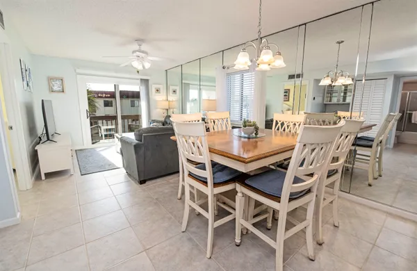 a dining room with furniture a chandelier and window