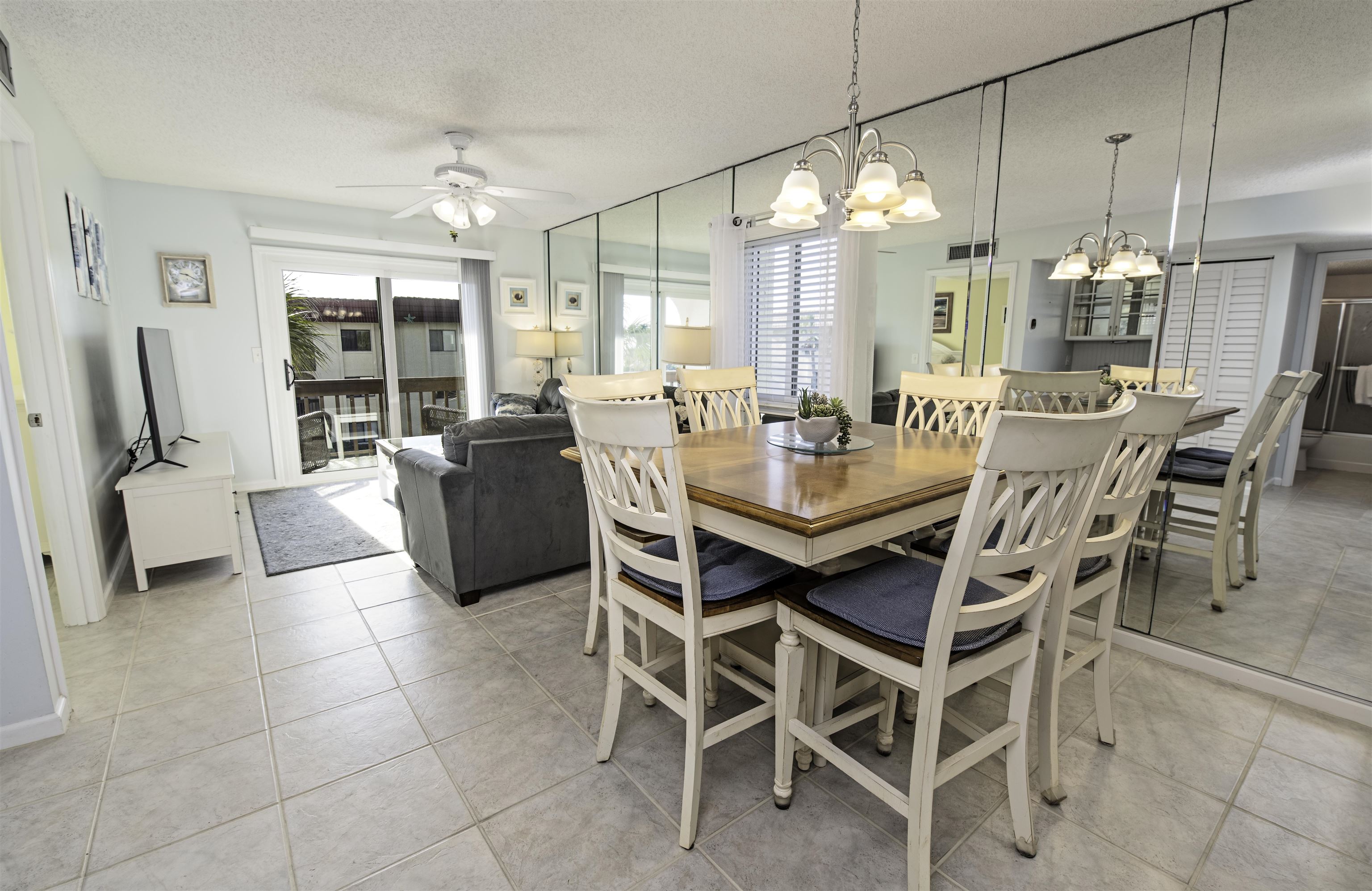 880 A1A Beach Boulevard, Unit 7302 St. Augustine, FL 32080 - Photo 3 of 28 a dining room with furniture a chandelier and window