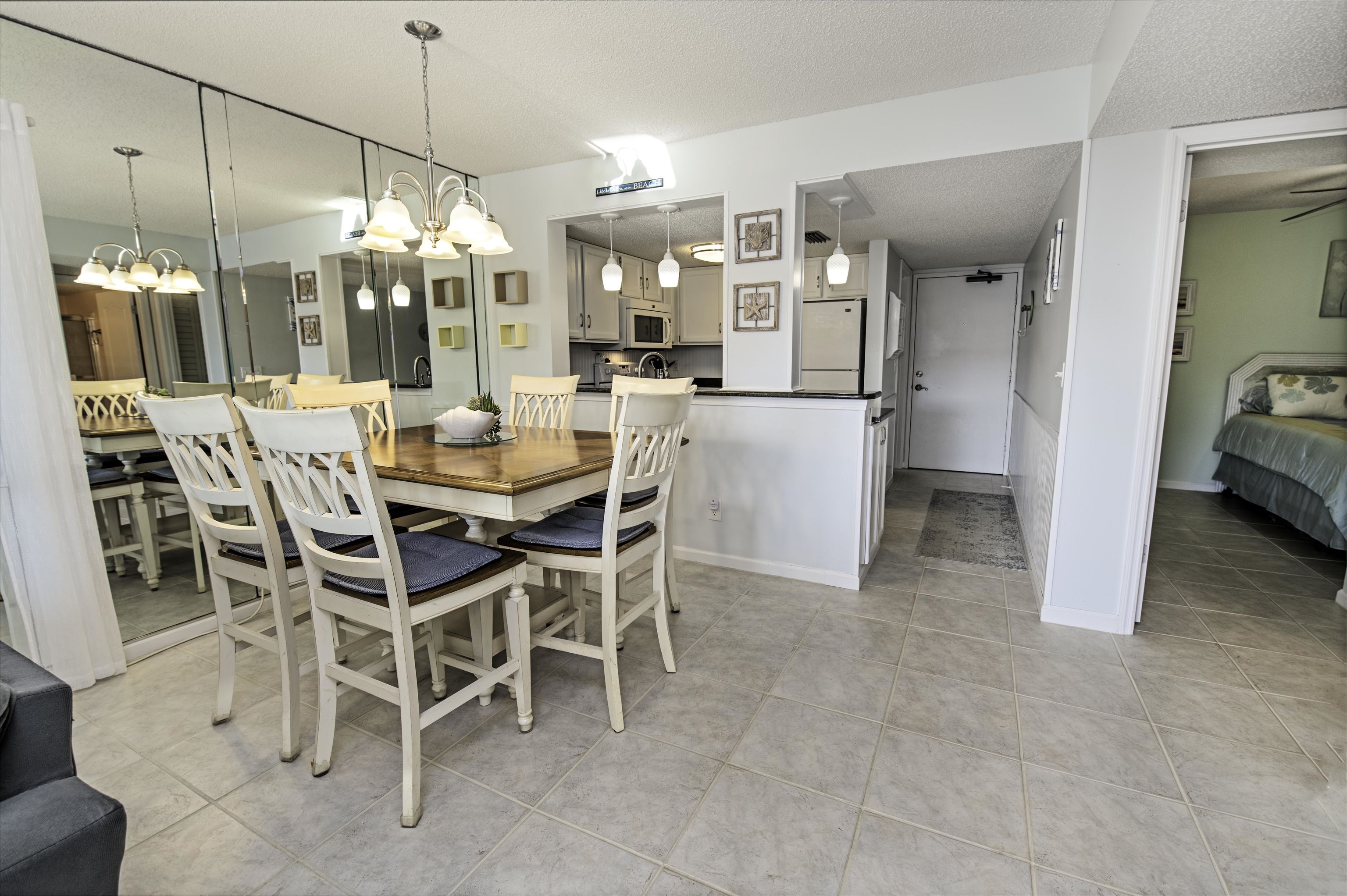 880 A1A Beach Boulevard, Unit 7302 St. Augustine, FL 32080 - Photo 4 of 28 a view of a dining room with furniture window and wooden floor