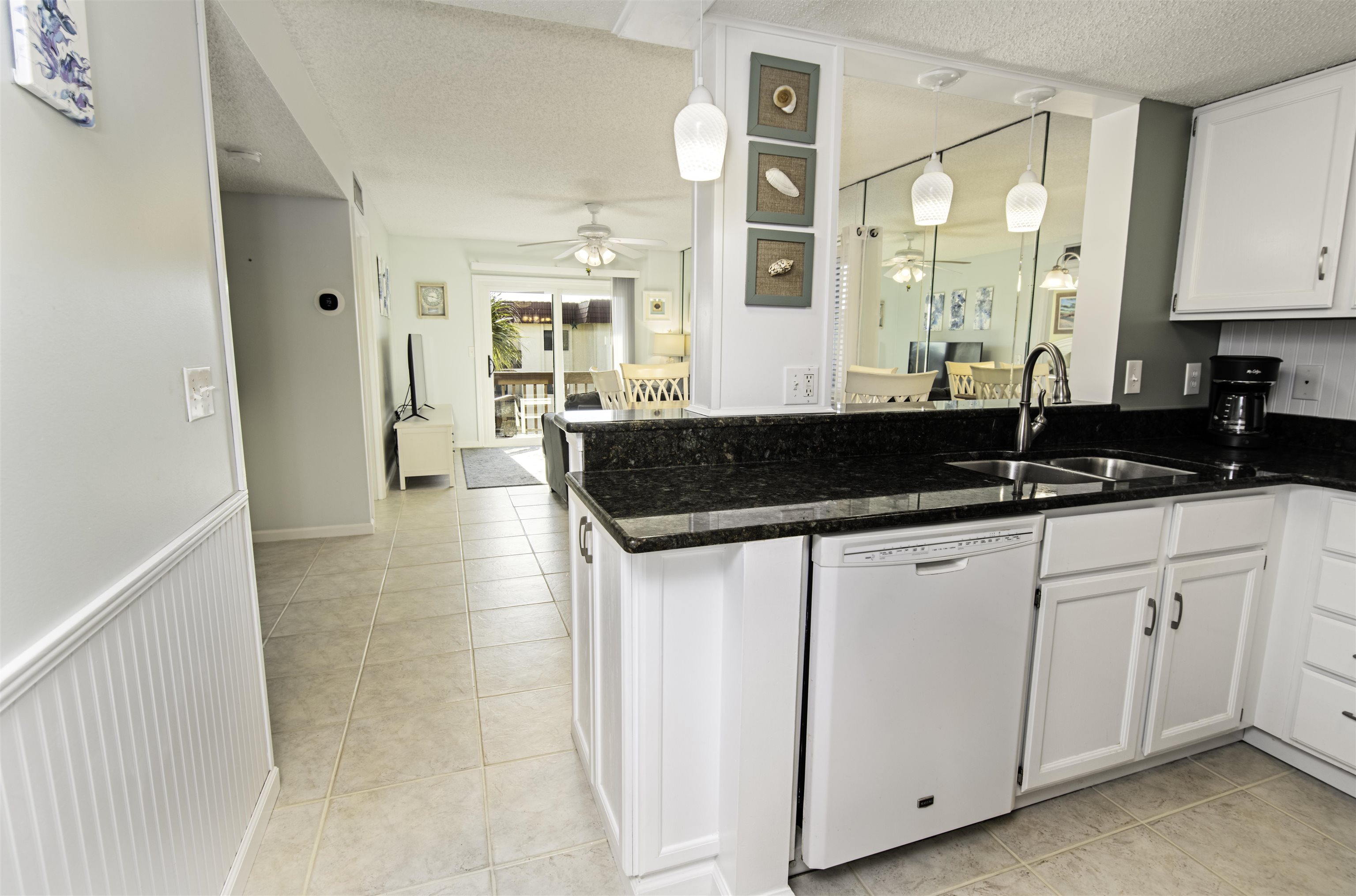 880 A1A Beach Boulevard, Unit 7302 St. Augustine, FL 32080 - Photo 5 of 28 a kitchen with a sink and cabinets