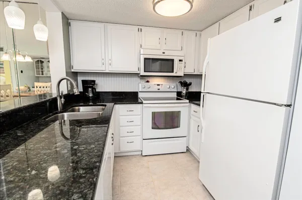a kitchen with a refrigerator a stove a microwave and cabinets