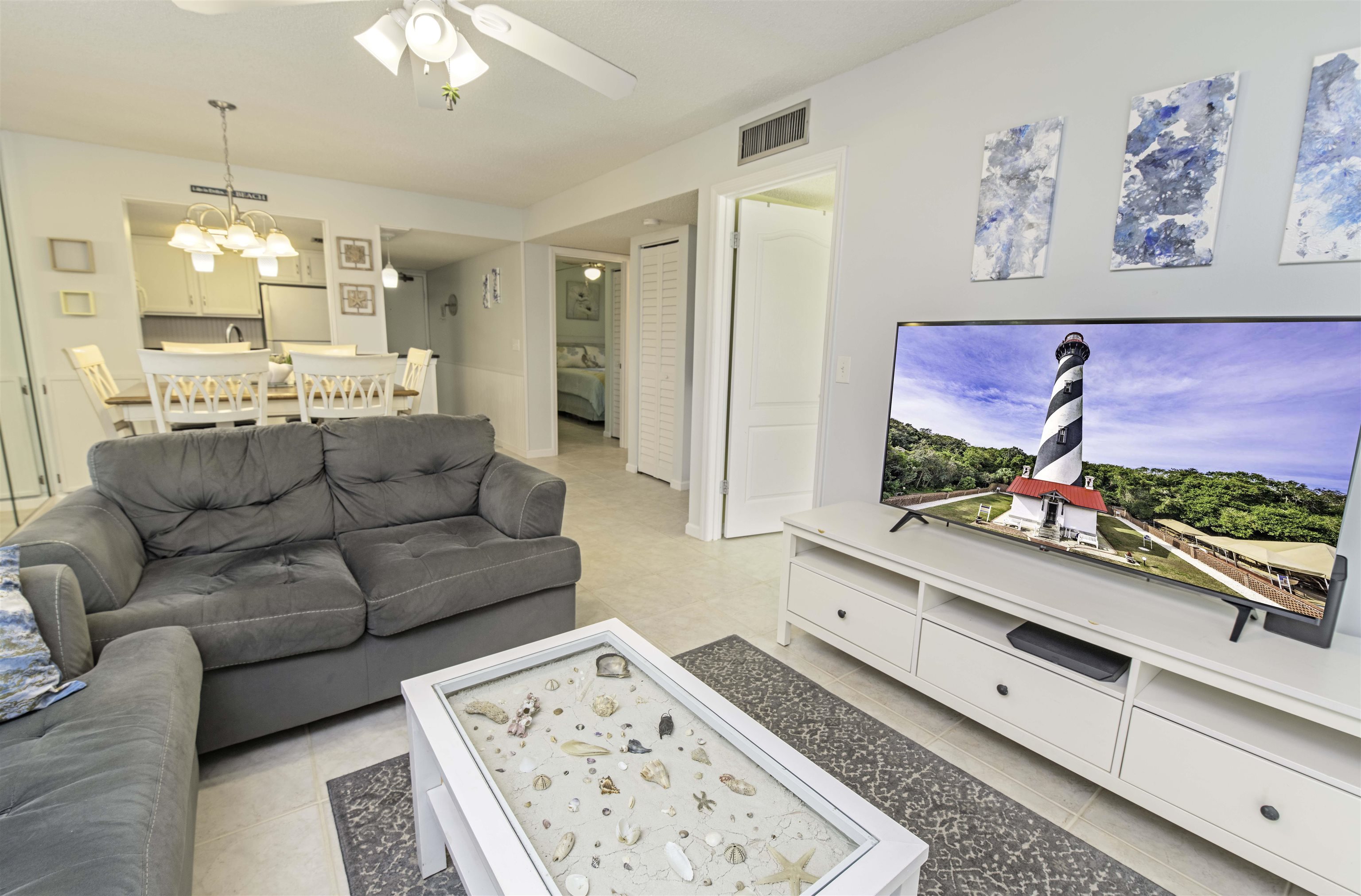 880 A1A Beach Boulevard, Unit 7302 St. Augustine, FL 32080 - Photo 9 of 28 a living room with furniture and a flat screen tv