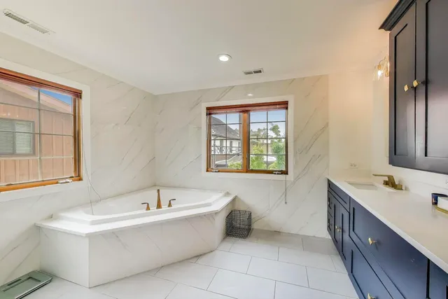 a spacious bedroom with a bed and a flat screen tv