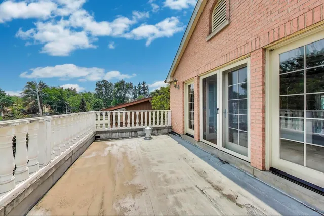 a bedroom with a bed and a flat tv screen on wall