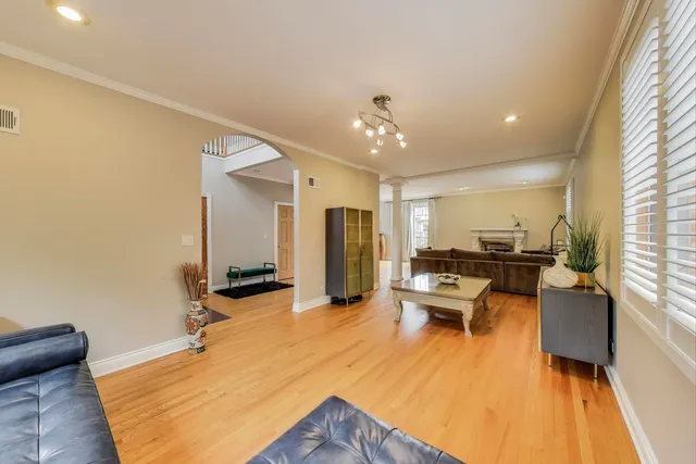 a living room with kitchen island granite countertop furniture and a chandelier