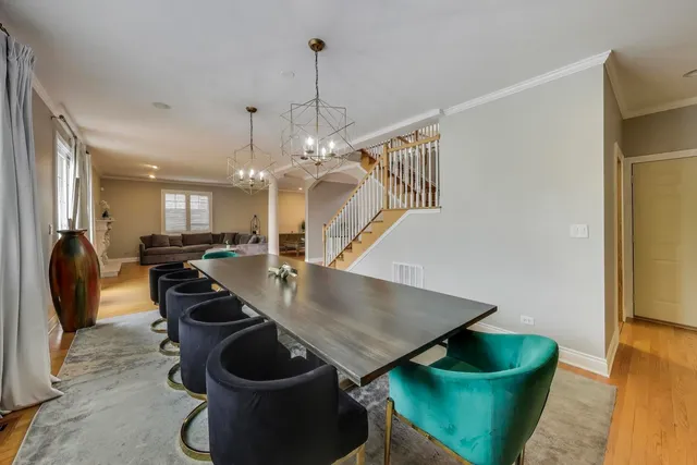 a kitchen with stainless steel appliances granite countertop a refrigerator a sink dishwasher a stove with wooden cabinets and floor