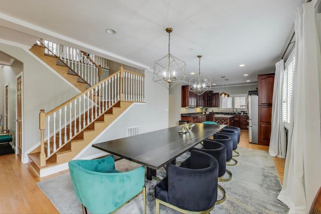 a kitchen with stainless steel appliances granite countertop a sink a stove and a wooden floors