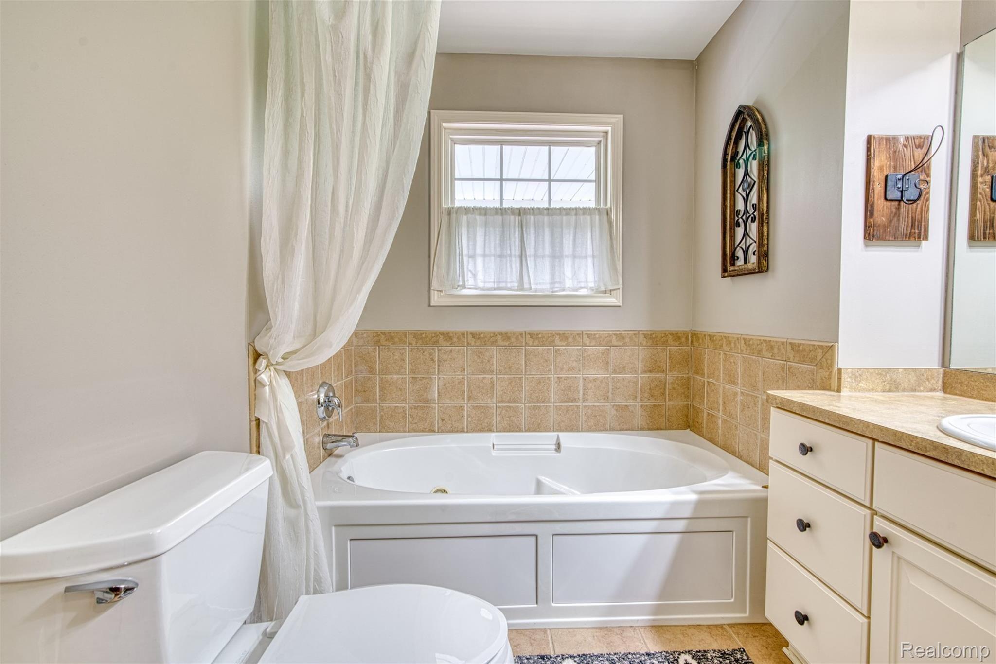 7016 West Lange Road Fowlerville, MI 48836 - Photo 23 of 61 HERE IS YOUR FAVORITE...A DEEP JACUZZI TUB...PERFECT!