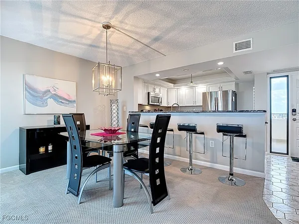 a kitchen with a sink a stove a refrigerator and cabinets