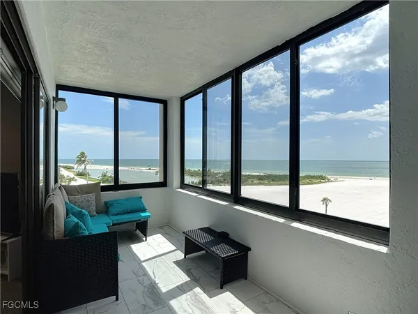 a living room with a large window and a table
