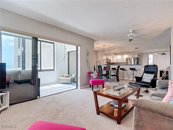 a view of a dining room with furniture a chandelier and wooden floor