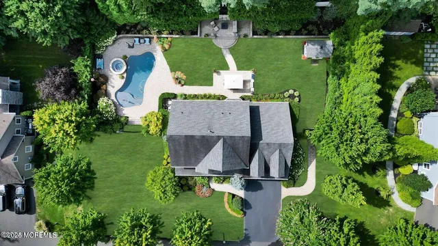 an aerial view of a house with outdoor space pool seating area and yard