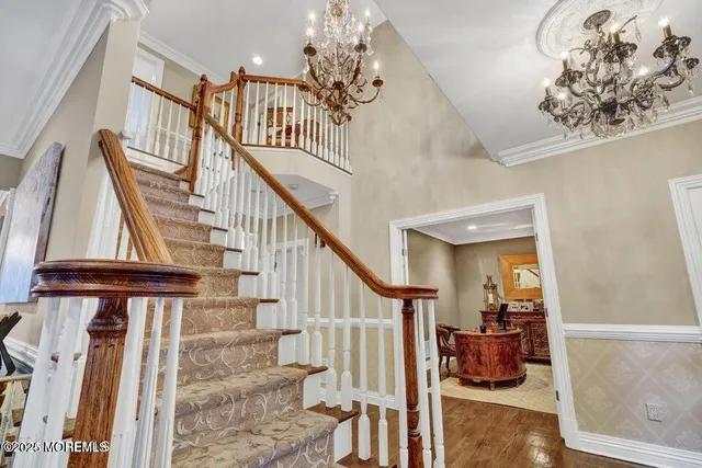 a view of entryway and hall with wooden floor
