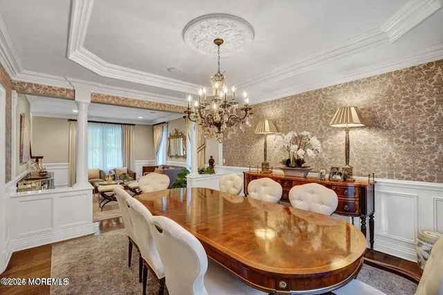 a dining room with furniture and chandelier