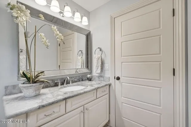a bathroom with a granite countertop sink vanity granite and a mirror