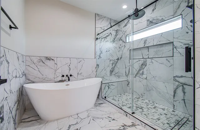 a white bath tub sitting in a bathroom