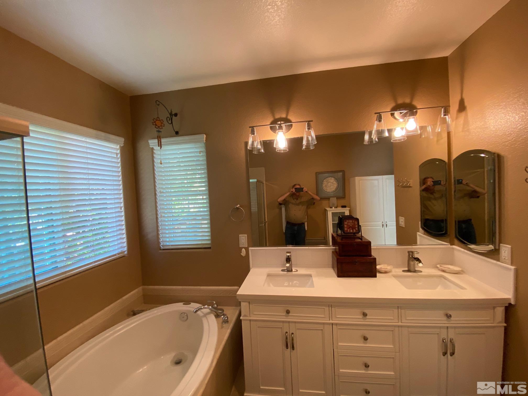 7875 Morgan Pointe Circle Reno, NV 89523 - Photo 20 of 31 a bathroom with a sink a large mirror and a bathtub