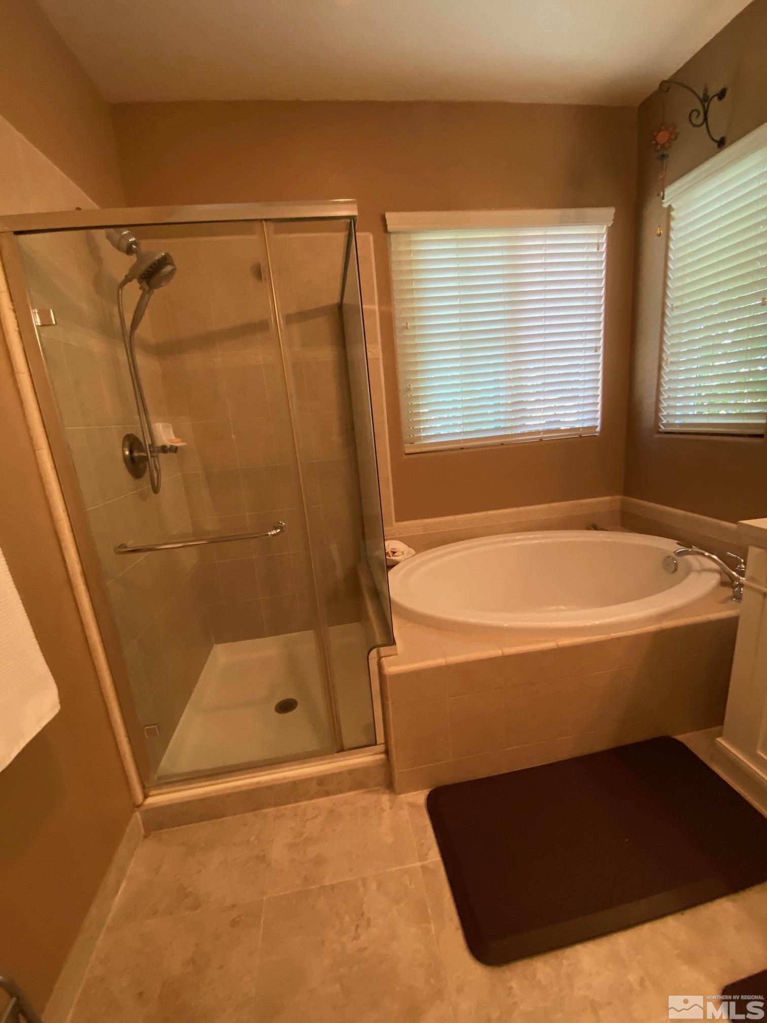 7875 Morgan Pointe Circle Reno, NV 89523 - Photo 21 of 31 a bathroom with a bathtub and a shower