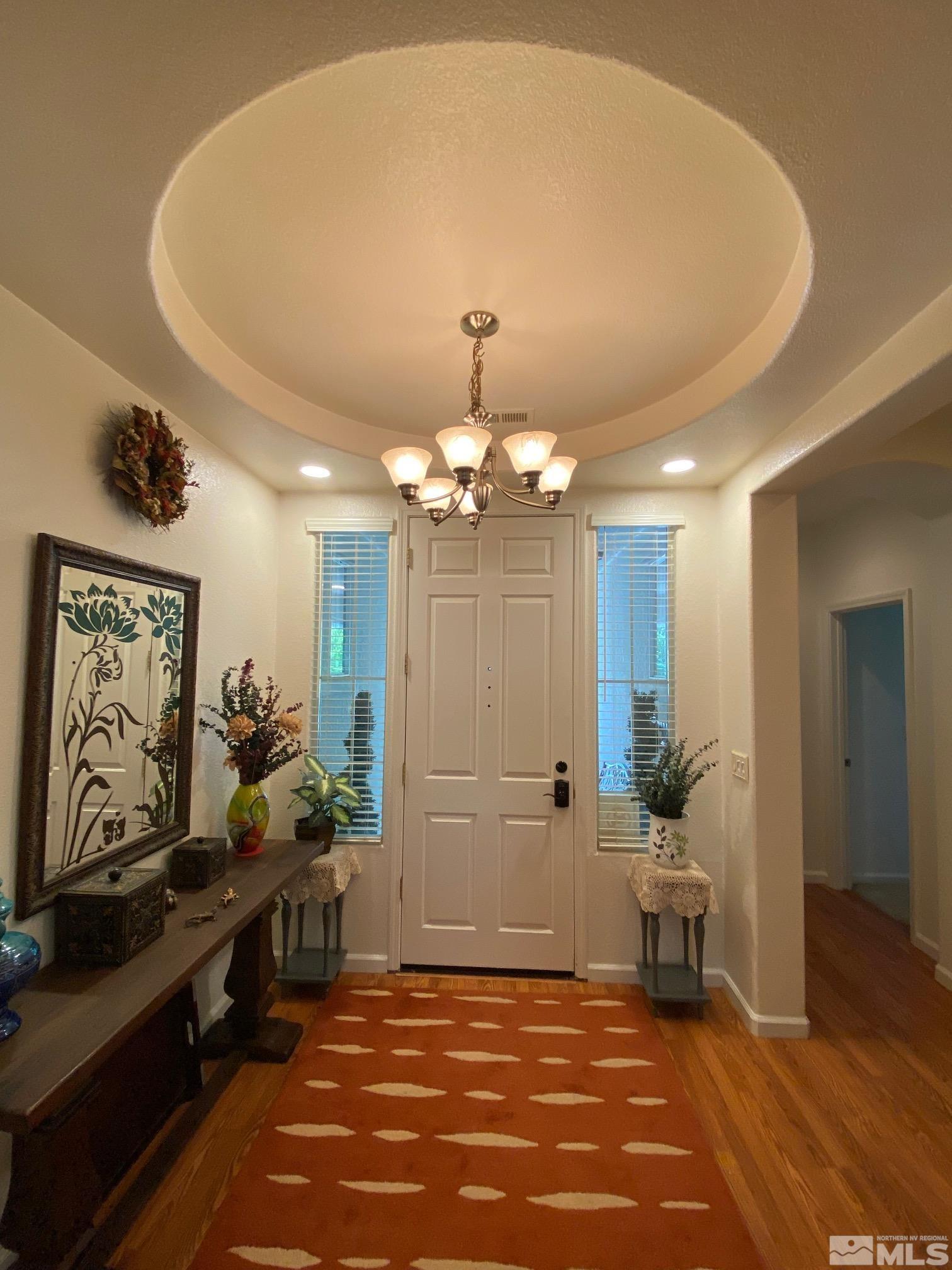 7875 Morgan Pointe Circle Reno, NV 89523 - Photo 6 of 31 a view of a room with gym equipment and a chandelier