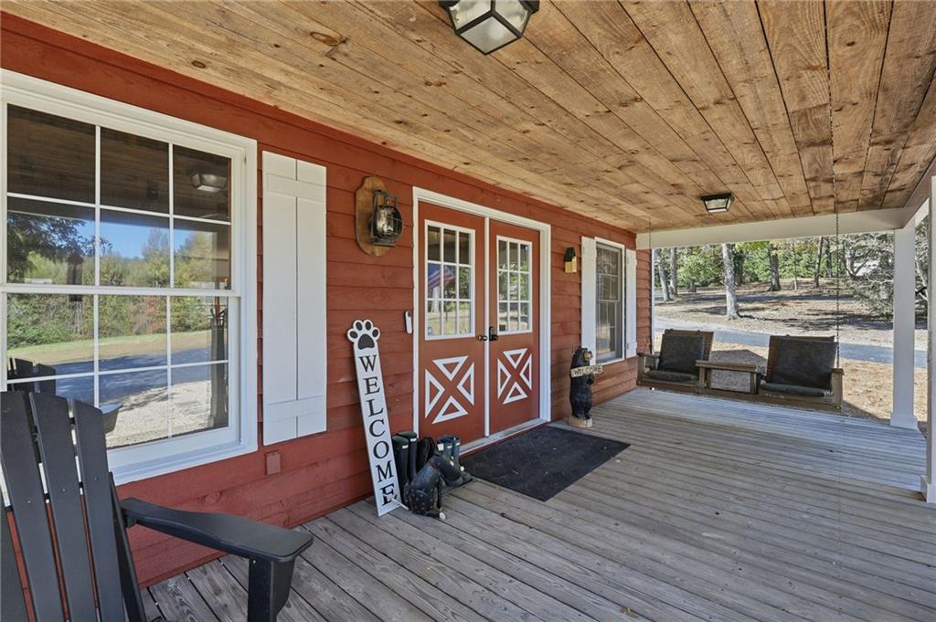 6752 Shoal Creek Road Clermont, GA 30527 - Photo 7 of 65 a view of a porch with furniture and wooden floor