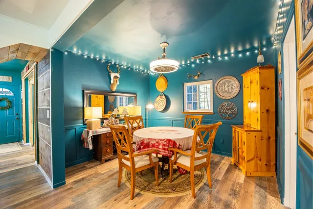 a view of a dining room with furniture and chandelier