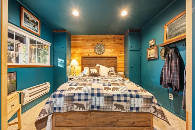 a bedroom with a bed and a large window