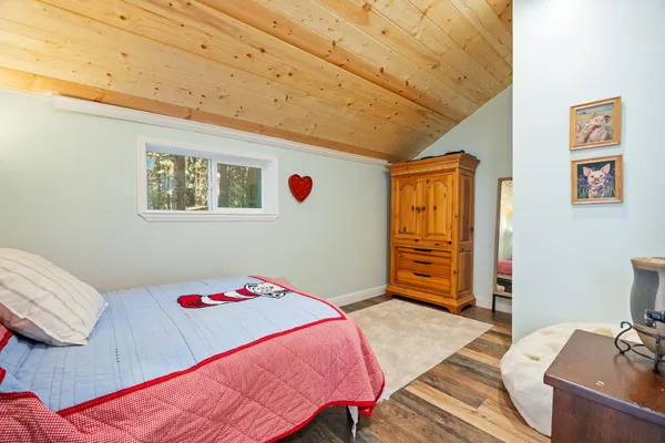 a bedroom with a bed and a dresser