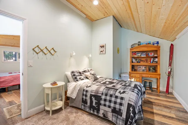 a bedroom with a bed and a book shelf