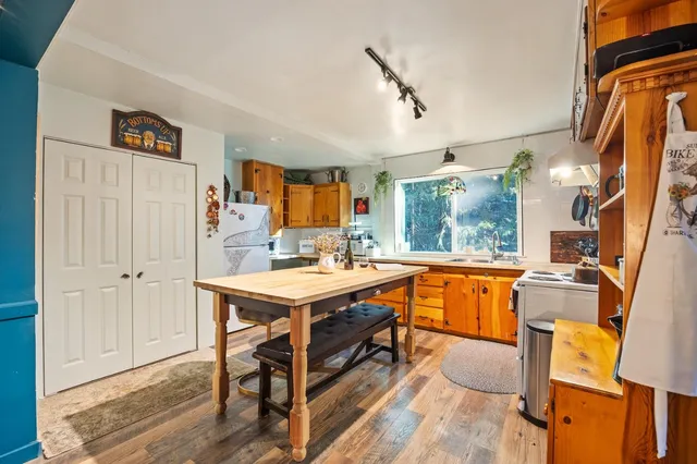 a large kitchen with a table and chairs in it