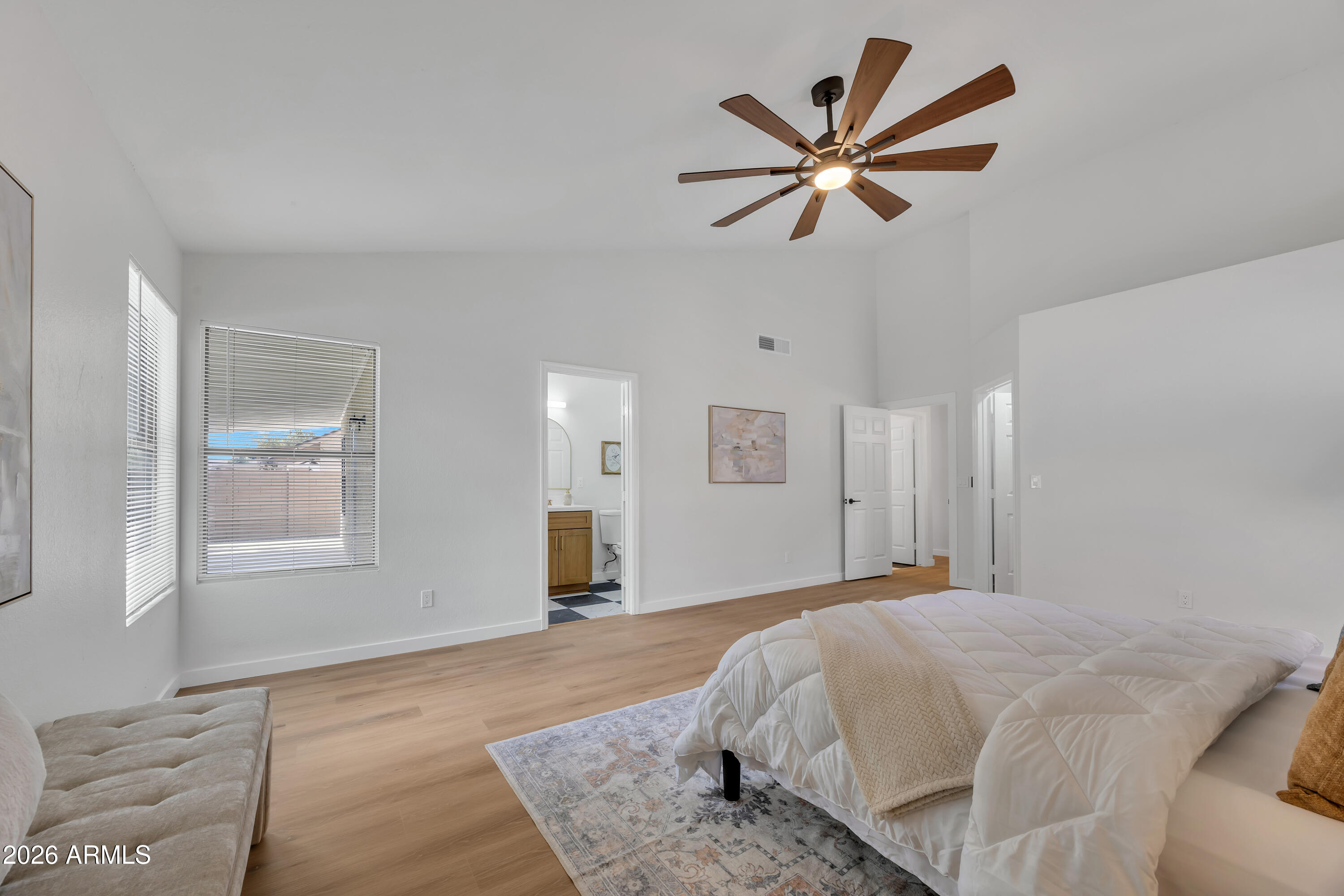 613 West Tara Court Gilbert, AZ 85233 - Photo 15 of 25 a bedroom with a large bed and a chandelier