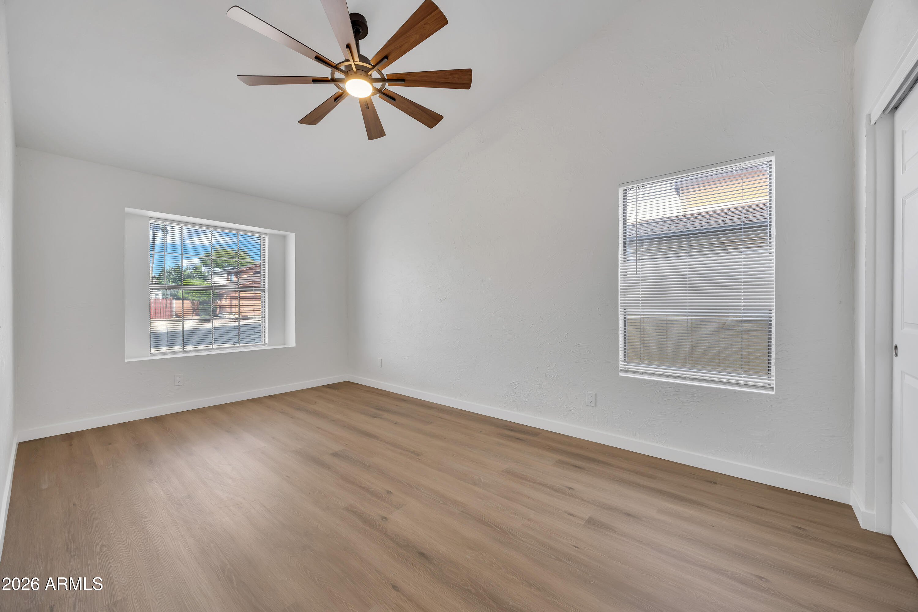 613 West Tara Court Gilbert, AZ 85233 - Photo 19 of 25 a view of an empty room with window and wooden floor