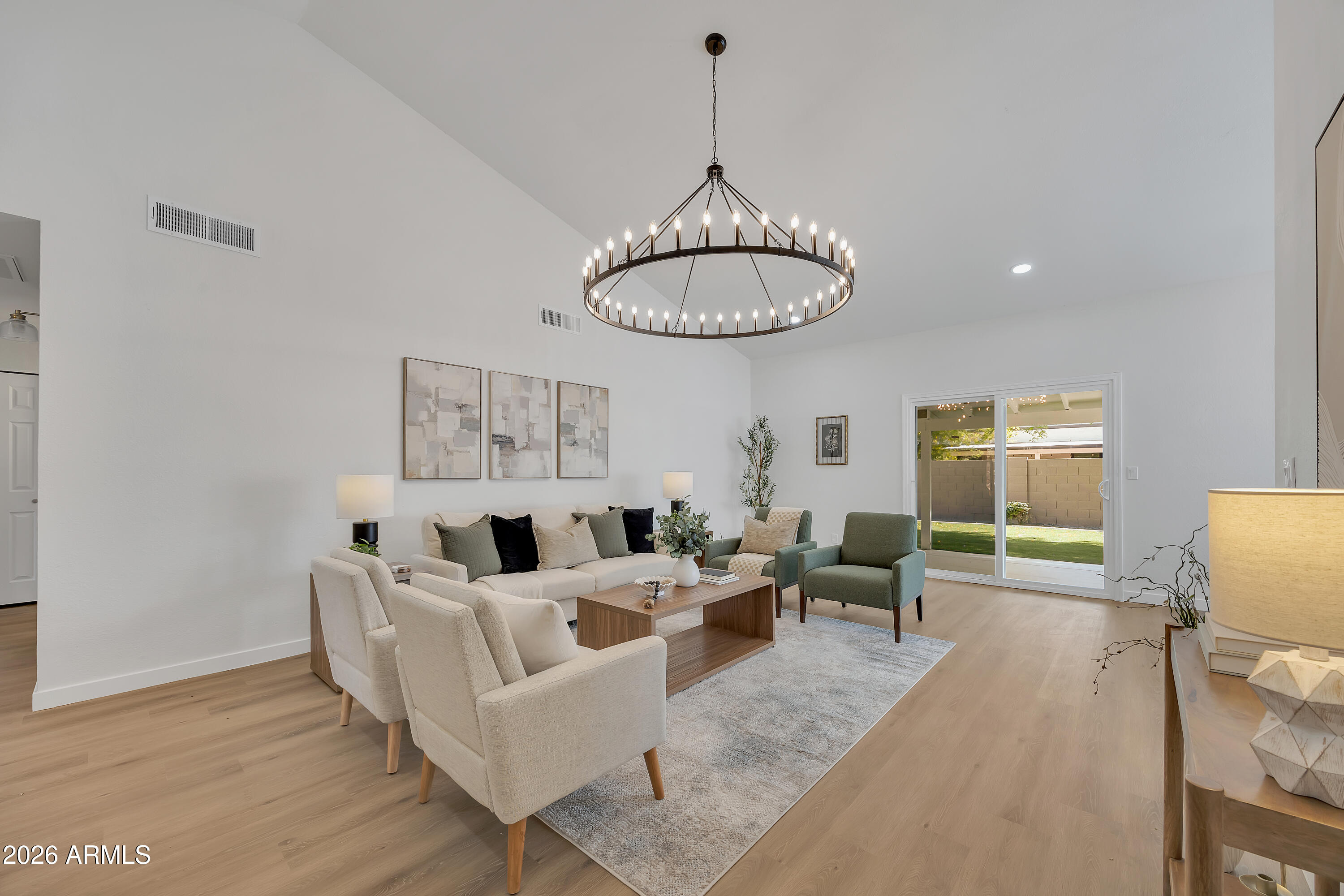 613 West Tara Court Gilbert, AZ 85233 - Photo 4 of 25 a living room with furniture a window and a chandelier
