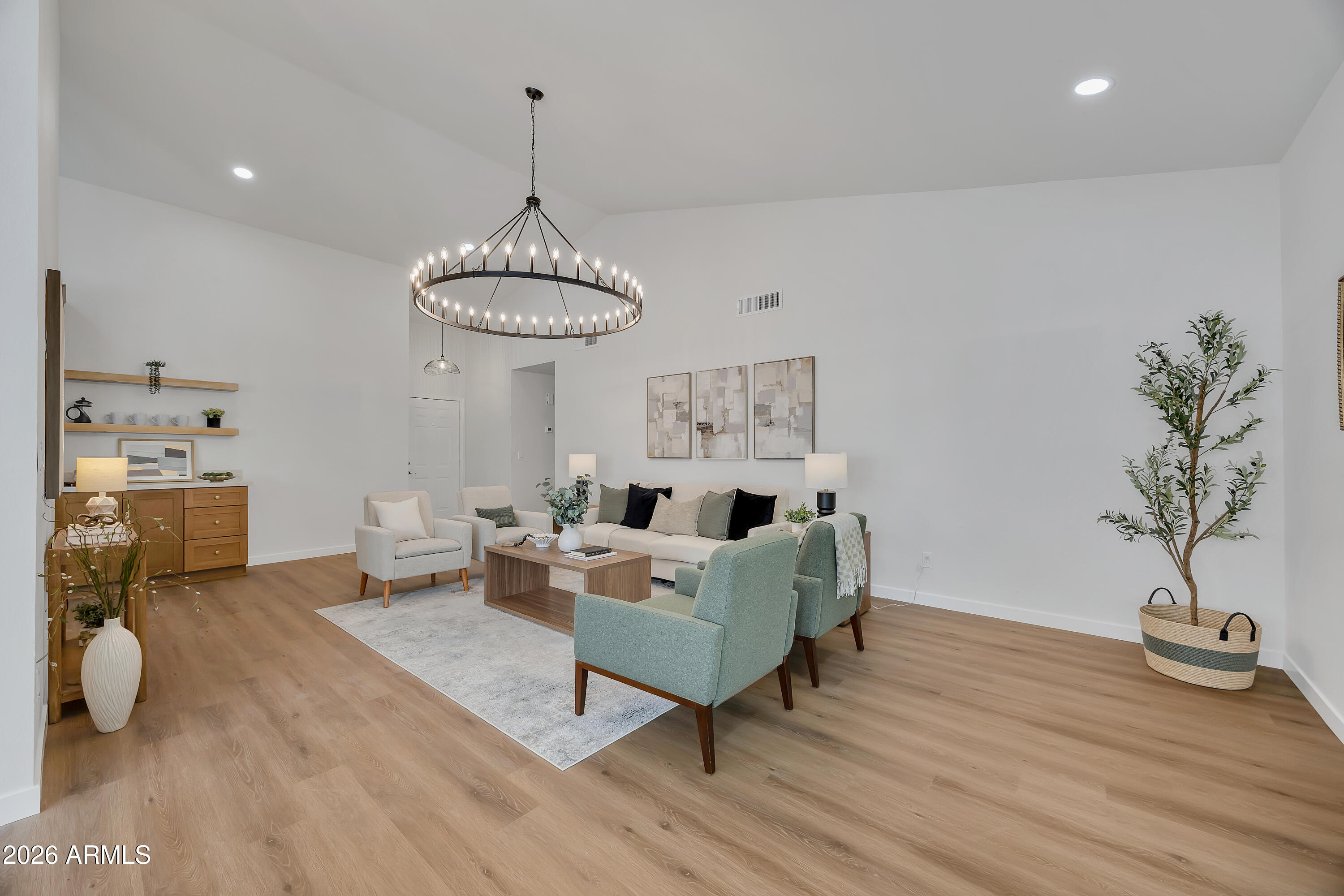 613 West Tara Court Gilbert, AZ 85233 - Photo 5 of 25 a living room with furniture a chandelier and a potted plant