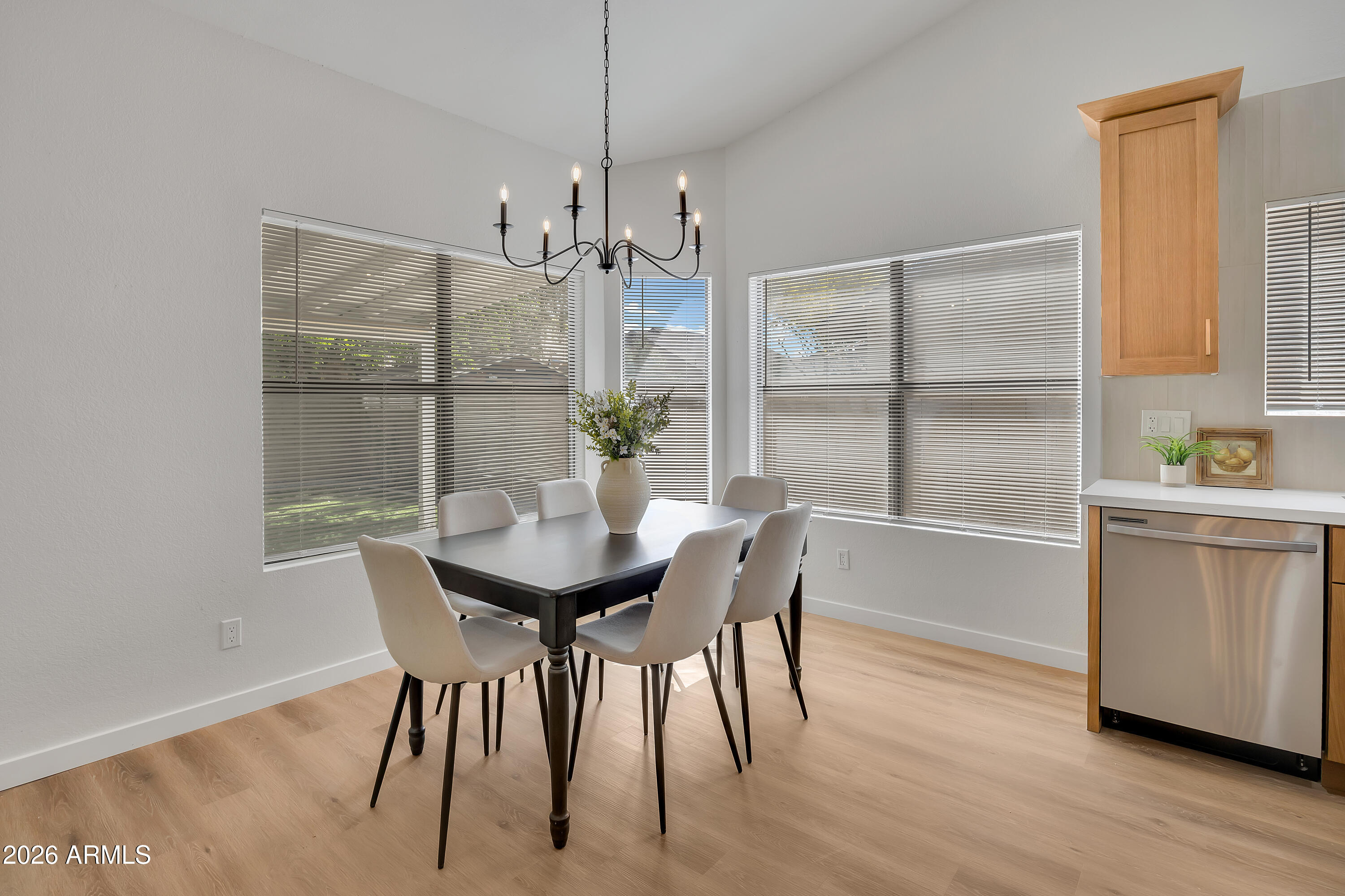 613 West Tara Court Gilbert, AZ 85233 - Photo 7 of 25 a view of a dining room with furniture window and wooden floor
