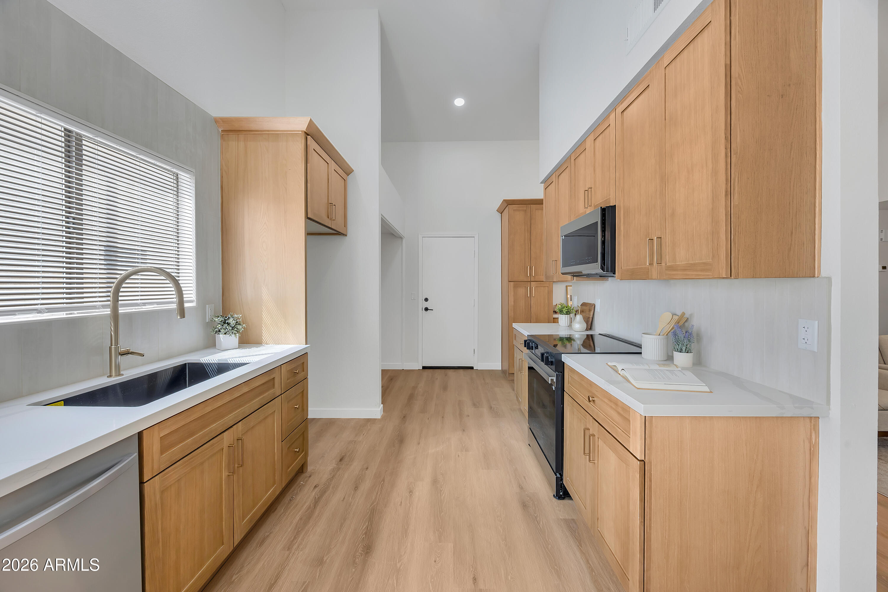613 West Tara Court Gilbert, AZ 85233 - Photo 9 of 25 a kitchen with a sink stove top oven and refrigerator