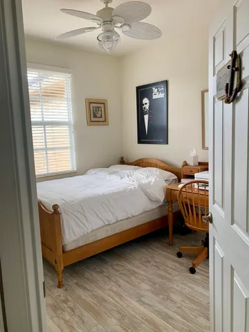a bedroom with a bed and wooden floor